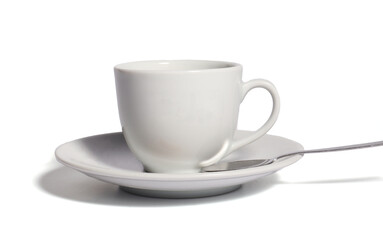 white cup on a saucer with spoon on white background
