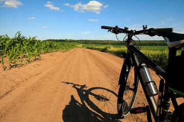 a man rides a bike and into the camera. man riding a bike in a field