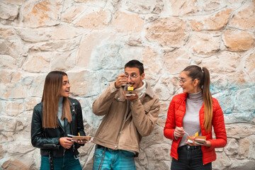 A group of students takes a break from college to rest and talk and eat delicious sweets.Selective...