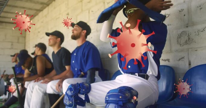 Animation of virus cells over diverse male baseball players sitting