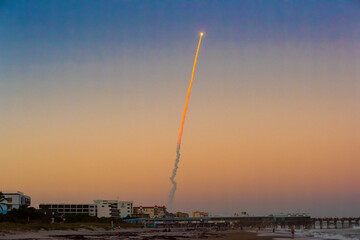 An Atlas V rocket launch from Kennedy Space Center viewed from Cocoa Beach, Florida - obrazy, fototapety, plakaty