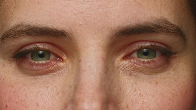 Close up woman face, blinking eyes looking at camera. Healthy vision, skincare anti aging treatment, eyesight surgery