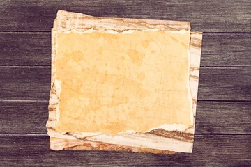 Inspirational handmade paper against rustic weathered wood, storytelling and narration concept.