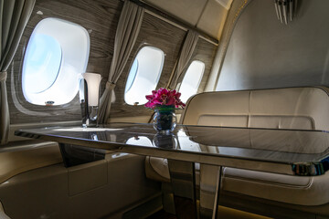 Interior of a business class of a commercial passenger plane, an armchair and a window.