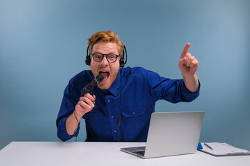 male radio host emotionally comments into a microphone on a blue background