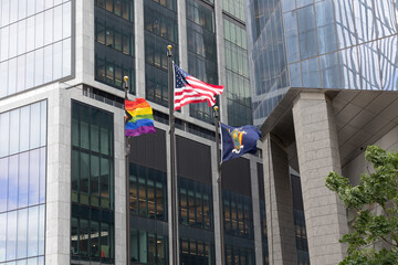 Pride flag flying along side the American flag and New York State flag