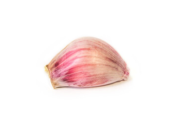 a clove of garlic lies on a white background