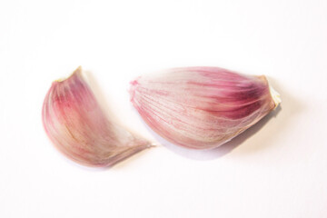 two cloves of garlic lie on a white background