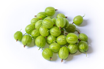 a lot of green gooseberries lies on a white background