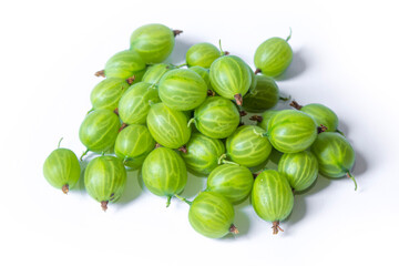 a lot of green gooseberries lies on a white background - obrazy, fototapety, plakaty