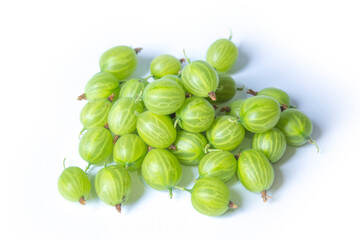 a lot of green gooseberries lies on a white background