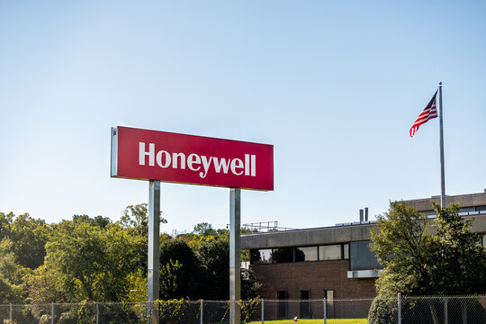 Colonial Heights, USA - October 18, 2021: Honeywell International Inc Manufacturer company office building entrance sign with american flag on pole flagpole in Virginia with nobody