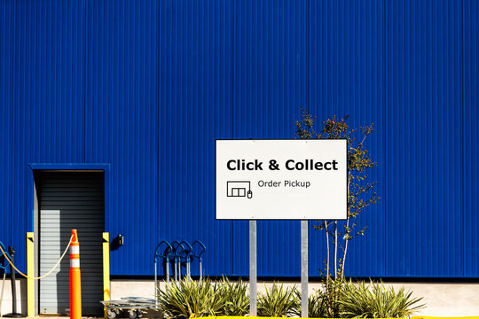 Jacksonville, USA - October 19, 2021: Sign for IKEA home furnishings furniture warehouse center store building for click and collect order pickup directions in Florida