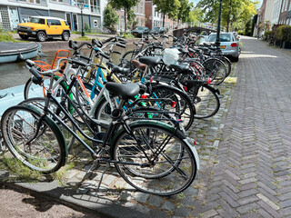 Fototapeta na wymiar Parking with different bicycles on city street