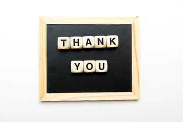 Top view of wooden cubes with thank you inscription