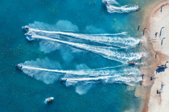 Aquabike championship on Jarun lake, Zagreb Croatia. Aerial view of the speed watercrafts in clear blue water at sunset in summer. Top view from drone of fast motorboats. Race. Water scooter