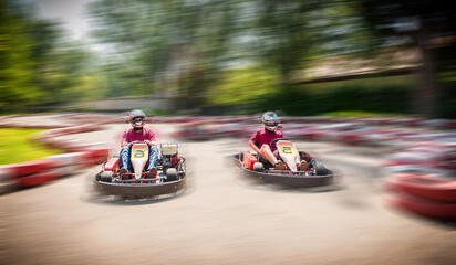 Go kart speed drive race sport contest with motion blur effect - obrazy, fototapety, plakaty