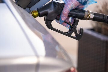 Diesel price in Europe. Refueling the car.Refueling pistol in the hands of a man in a blue...