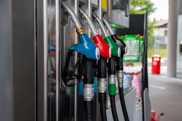 Petrol pump filling nozzles at gas station. Blue, red, green, black color fuel gasoline dispenser...