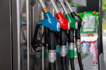Petrol pump filling nozzles at gas station. Blue, red, green, black color fuel gasoline dispenser...