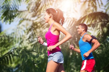 Happy slim woman wearing sportswear jogging in the city. Workout exercise in the morning. Healthy and active lifestyle concept.