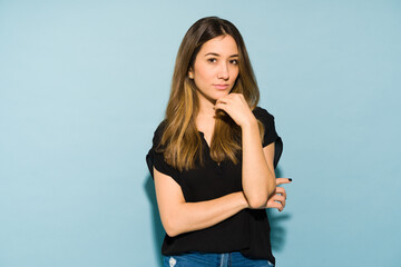 Beautiful woman in casual clothes looking confident in a studio