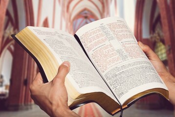 Fototapeta premium Hands of prayer on a Holy Bible in church concept for faith, spirtuality and religion