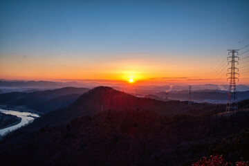 Scenic views of mountains and river against sky during sunrise