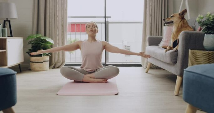 Young caucasian woman meditating while practicing yoga at home. One female athlete working out and exercising inside. Focus, relax, find your center and better the health of your body and mind