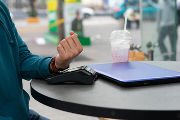 unrecognizable hand makes contactless payment with an smartwatch with text slot