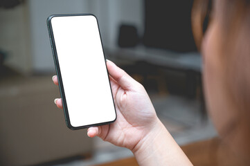Close up women using a smartphone with an empty white screen at home.