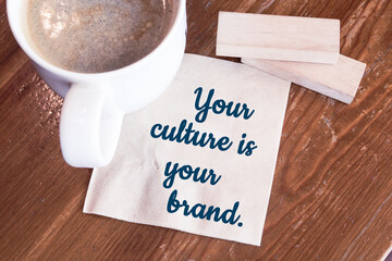 Your culture is your brand - handwriting on a napkin with a cup of coffee