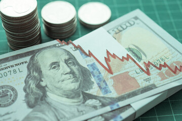 Tear off US dollar banknote and coins stacks as chart graph down. The Federal Reserve ( FED )...