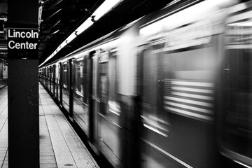 New York City subway train in motion in empty Lincoln Center Station 