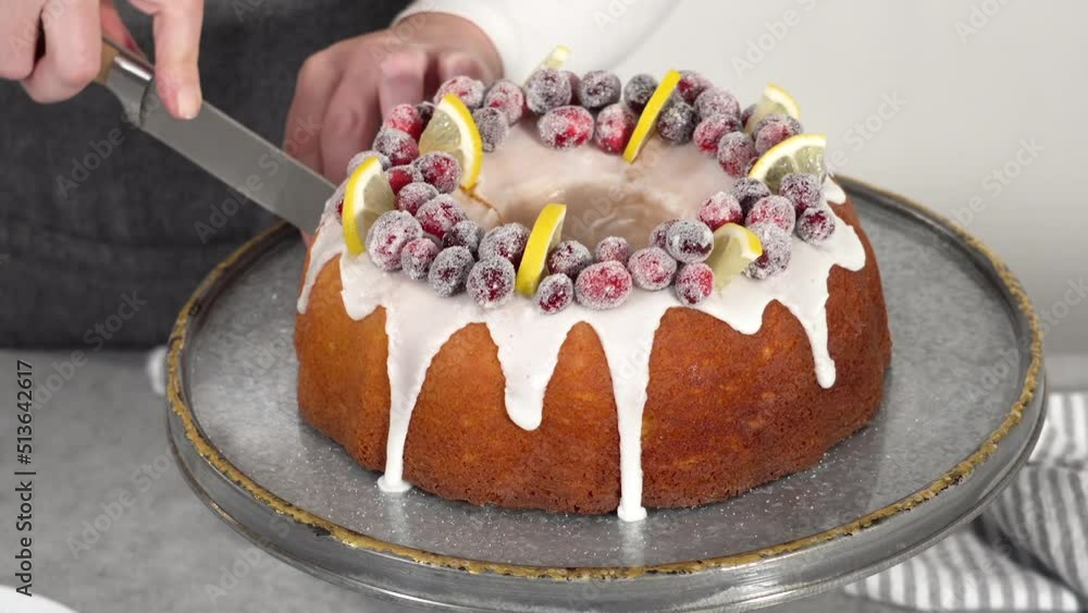 Poster step by step. slicing lemon cranberry bundt cake decorated with sugar cranberries and lemon wedges.