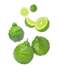 Fresh bergamot or kaffir lime fruit with slice flying in the air isolated on white background. 