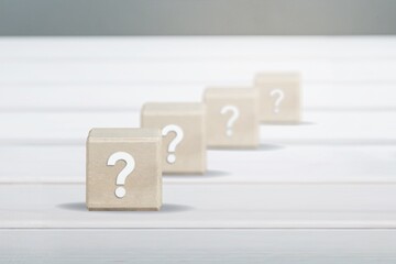 wooden blocks with a question mark. frequently asked questions marketing plan for educational ideas