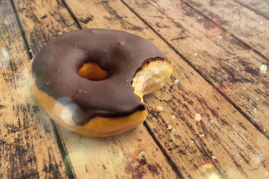 Tasty Sweet Chocolate Glazed Donut With Crumbs And Creme Filled