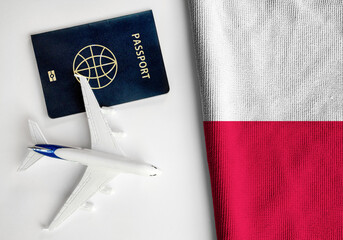 Flag of Poland with passport and toy airplane. Flight travel concept
