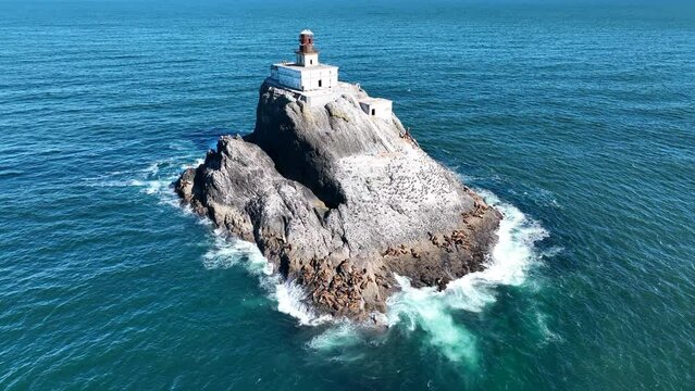 The cold water of the Pacific Ocean surrounds the deactivated Tillamook Rock Lighthouse off the scenic Oregon coast. The isolated, historic lighthouse was originally built in 1880.