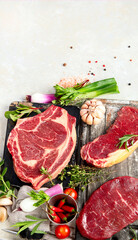 Variety of raw beef meat steaks for grilling.