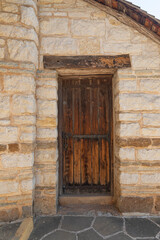 Wooden antique and rustic door under old construction.