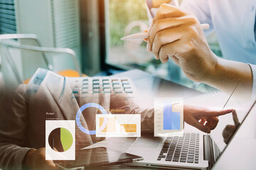 Businessman hands working with finances about cost and calculator and laptop with tablet, smartphone at office in morning light