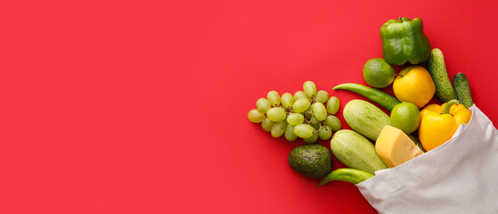 Eco bag full of food on red background with space for text, top view