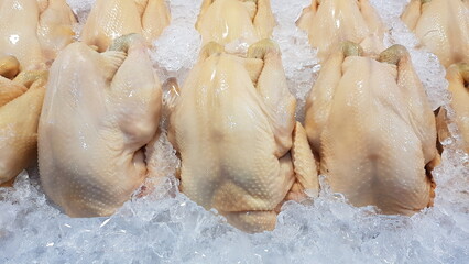 Fresh chicken placed on ice trays in the fresh market.