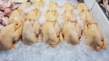 Fresh chicken placed on ice trays in the fresh market.