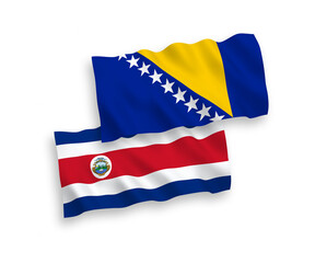National vector fabric wave flags of Republic of Costa Rica and Bosnia and Herzegovina isolated on white background. 1 to 2 proportion.