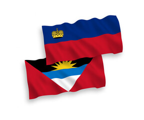 National vector fabric wave flags of Liechtenstein and Antigua and Barbuda isolated on white background. 1 to 2 proportion.