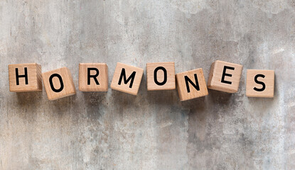 Naklejka premium Word HORMONES made of cubes on grunge background