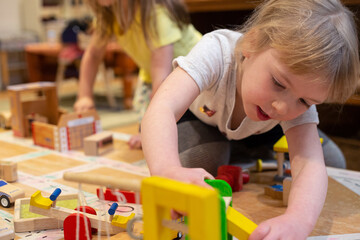 Young girl child playing with building toys
